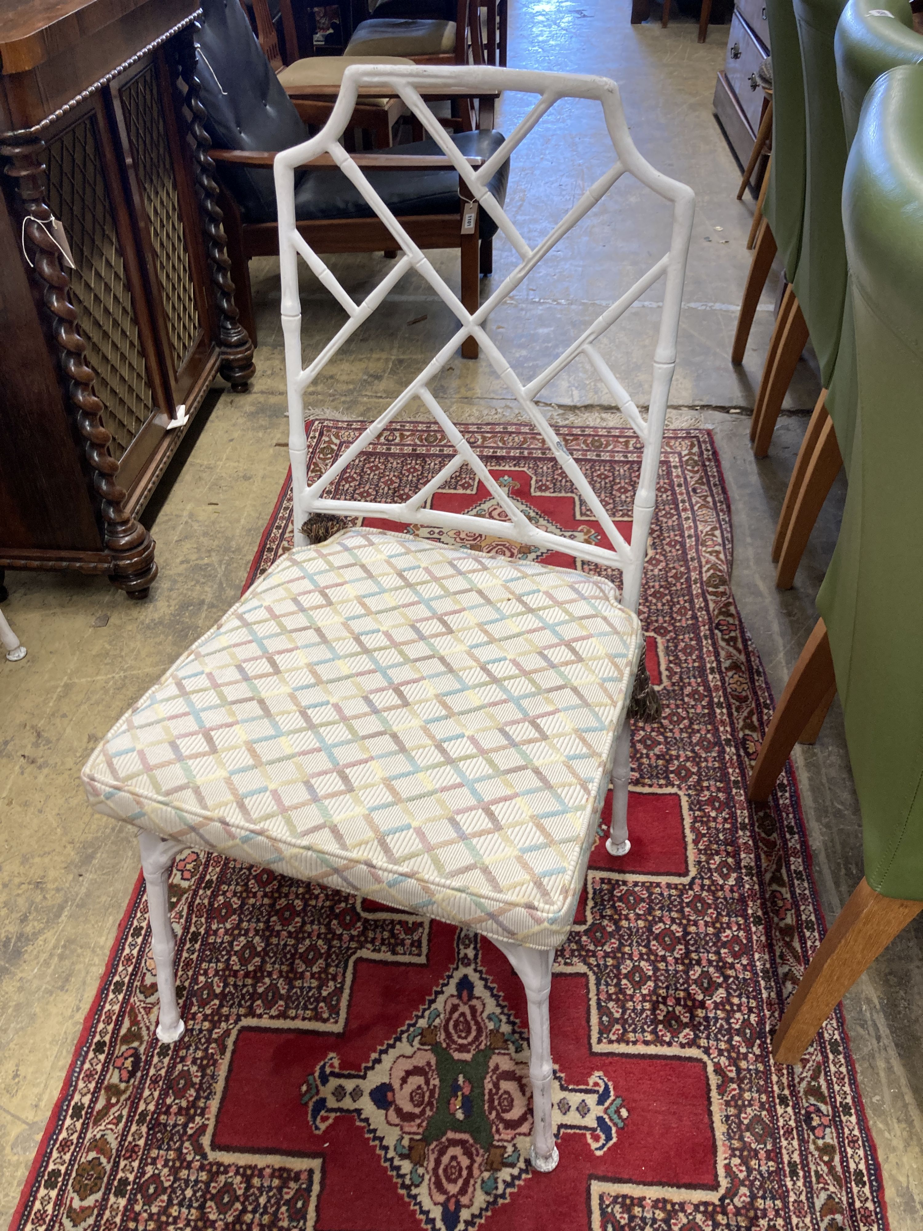 A faux bamboo circular garden table, 98cm diameter, height 72cm together with a set of four painted aluminium faux bamboo garden chairs, two with arms
